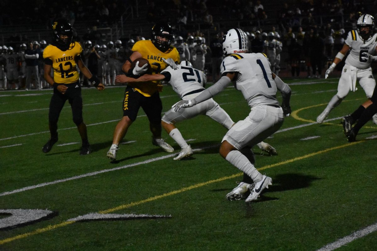 Running+back+senior+Kaito+Inoue+attempts+tries+to+break+a+tackle+during+a+September+2023+game+against+Sonora+High+School+at+Buena+Park+High+School+stadium.+Because+of+the+CIF-Southern+Section+releaguing+that+will+start+in+the+2024-2025+season%2C+the+Lancers+will+no+longer+compete+against+the+Raiders+as+the+former+will+play+in+the+Lambda+division%2C+while+the+latter+will+play+in+the+Iota+division.