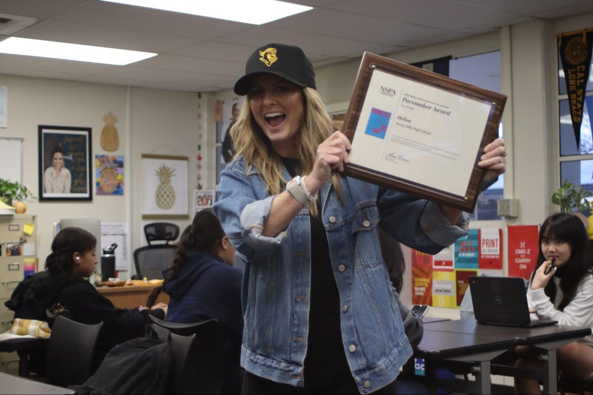 Helios adviser Lindsay Safe presents the National Scholastic Press Association Pacemaker award to her fourth-period yearbook class on Friday, April 12, in Room 62. The award is for the 2022-2023 yearbook titled, “Honestly Who Says We Can’t?” making this the publication’s third such Pacemaker plaque.