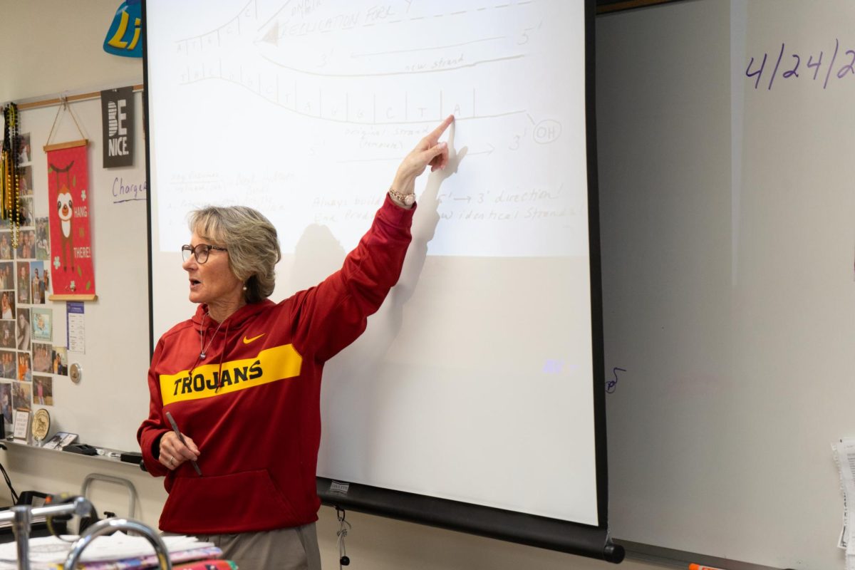 Science teacher Kathy Bevill points to the screen while teaching her sixth period biology class in Room 102 on Wednesday, April 24.