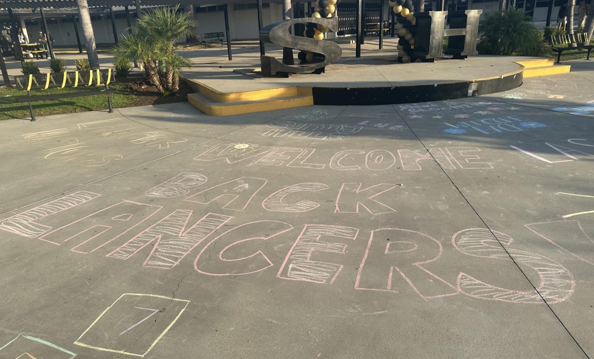 A chalk-written message in the quad greets students returning to the campus to start the first day of the 2024-2025 school year on Monday, Aug. 12. Associated Student Body [ASB] students came to campus before zero period to not only produce a welcome back message but also to decorate the rest of the quad and walkways bordering it. 