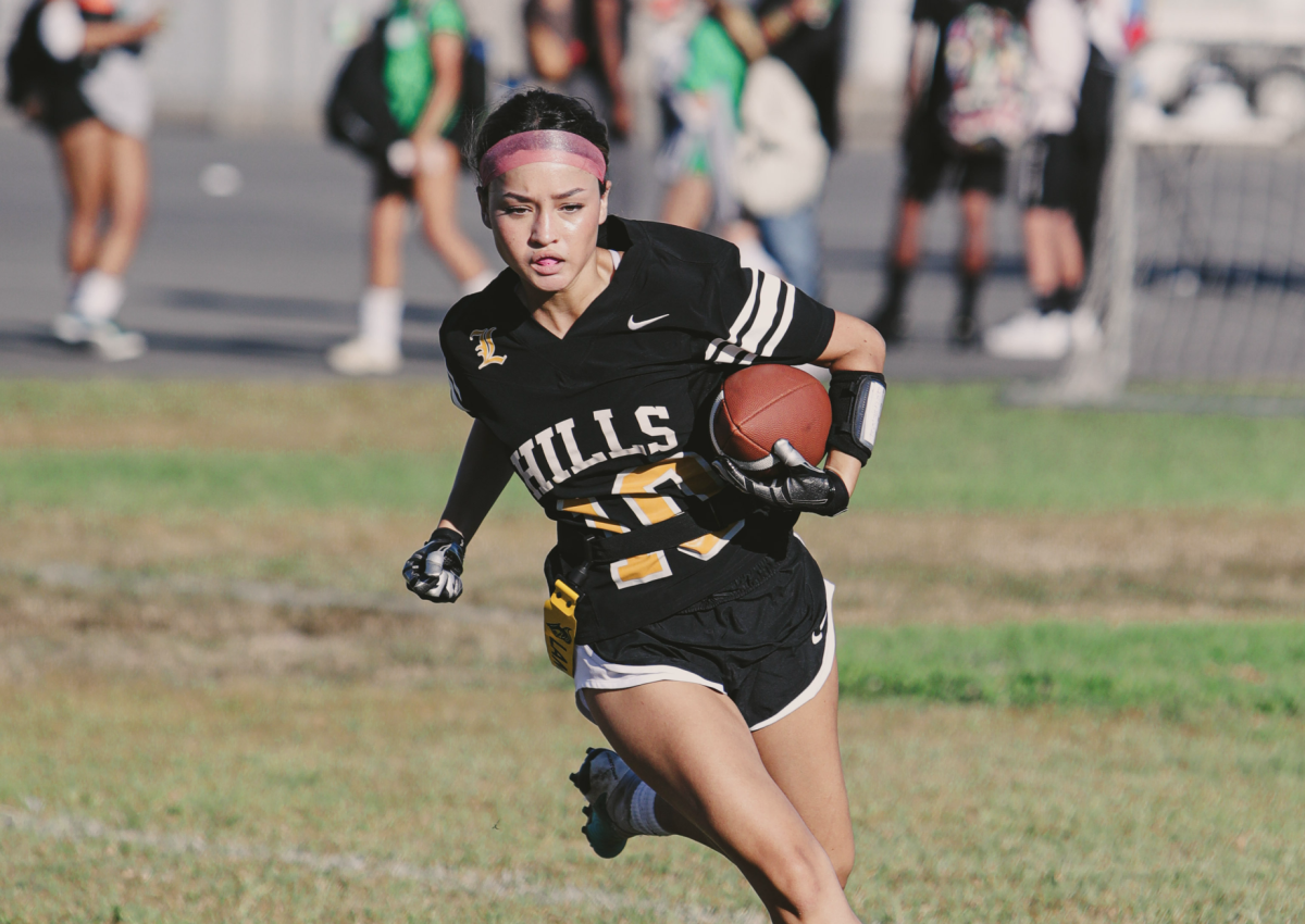 Running back senior Sloanne O’Connor sprints through the field with the ball during the game against Woodrow Wilson High School at Sunny Hills on Monday, Aug. 19.