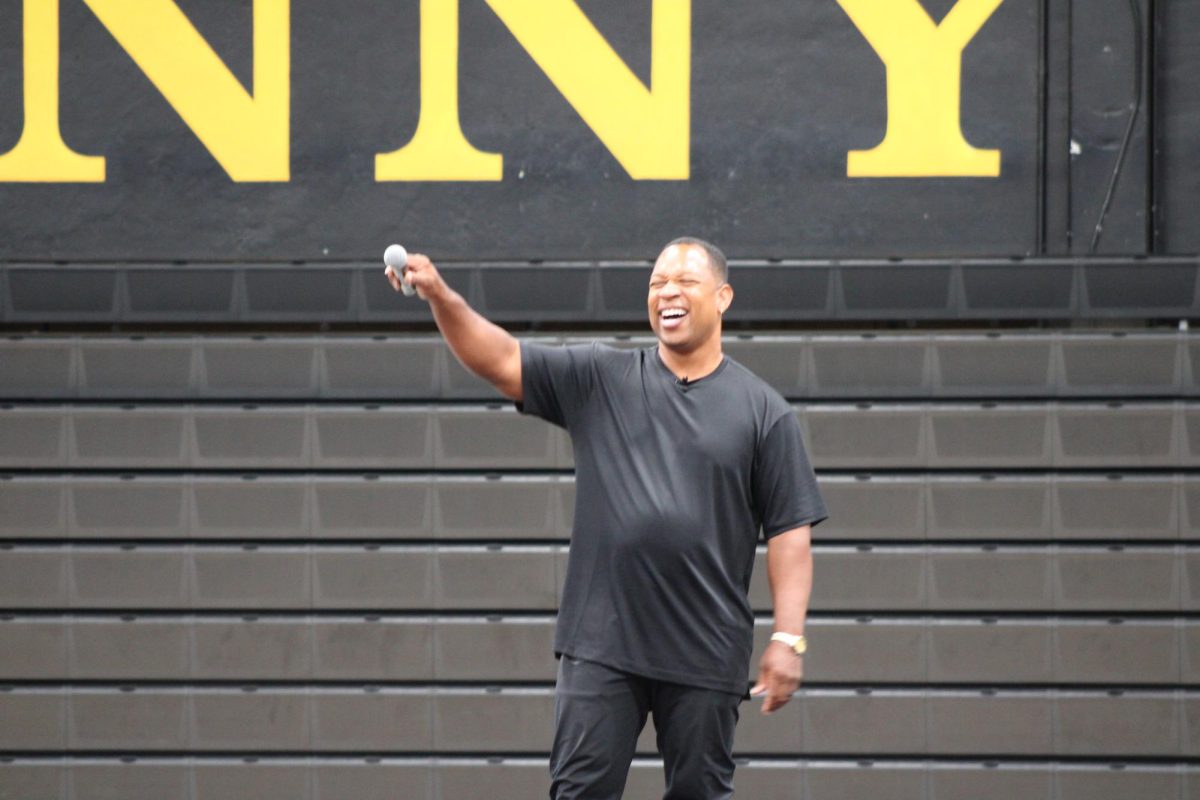 Guest speaker Keith Hawkins points his mic toward the audience as he asks for a cheer from the audience during the second of the double second period assembly in the gym on Tuesday, Sept. 10. Hawkins was invited to speak to students during a special gathering to share how his hardships and experiences shaped him as the person he is today. 