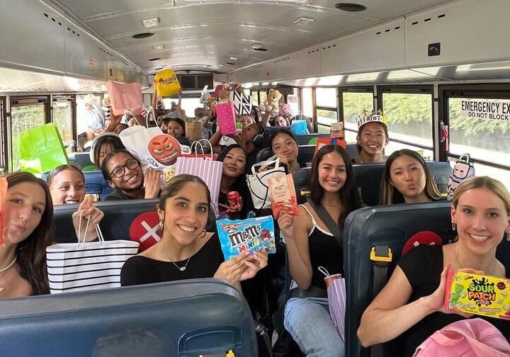 Girls volleyball players hold their sister gifts on the way to their game against La Serna High School in the bus on Friday, Aug. 23.