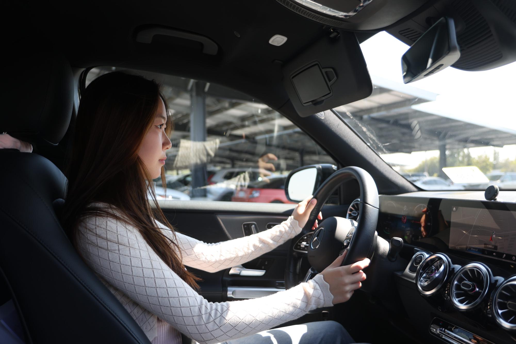 Senior Faith Jung drives her car in the south parking lot in search of a parking space on Monday, Sept. 30. (Photo by Noah Lee)