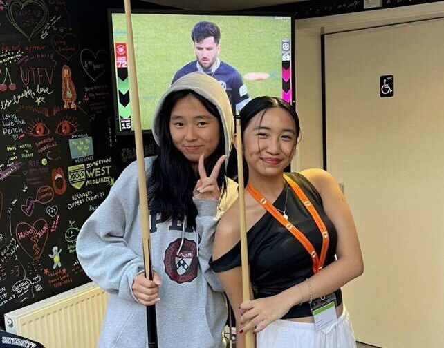 Juniors Chloe Aeum (left) and Renee Reyes, who attends Philippine Science High School, pose with a cue stick at Oxford University’s terrace cafe on Tuesday, July 30, during the Oxford Summer Courses held from Sunday, July 21-Saturday, Aug. 3.