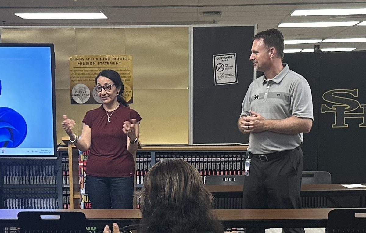 Parent volunteer Ivonne Wang (left) translates into Spanish principal Craig Weinreich's introductory message to the 20 Spanish-speaking adults attending the first meeting of the Hispanic Parent Outreach on Wednesday, Sept. 25, from 5:30-7 p.m. in the library. Wang, a council representative for the Parent Teacher Student Association, came up with the idea of forming the Spanish-speaking support group.