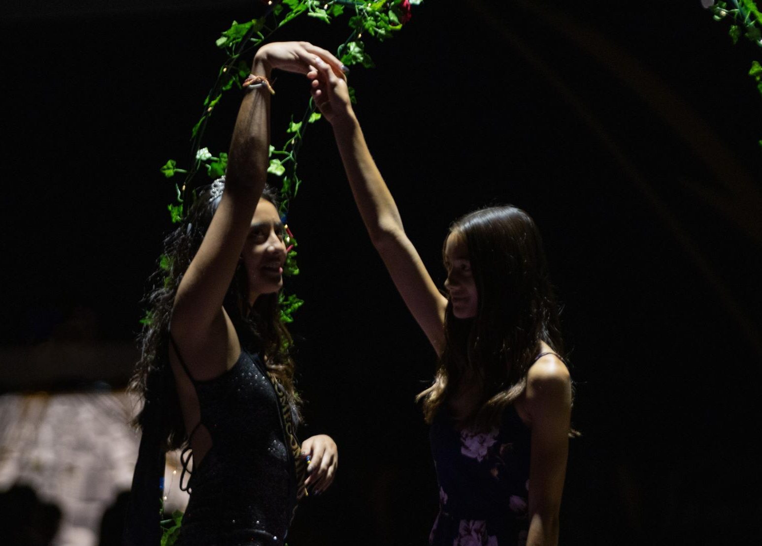 2023 homecoming court nominee then-senior Mikayla Sooter holds her escort's hand to spin during the Sept. 29, 2023, assembly prior to the dance.