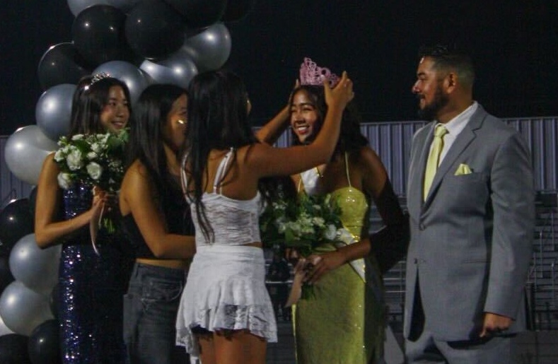 Senior Liv Chavez (second to right) receives her pink tiara upon the announcement of her homecoming queen title during the halftime of the Friday, Oct. 4, football game at the Buena Park High School stadium.