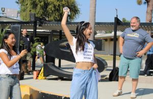 Senior Tiffany Kim, one of the seven selected for homecoming court, celebrates after winning a quad game involving water balloons during break on Monday, Sept. 30. For the first two days of the week leading up to Friday’s assembly, the Associated Student Body [ASB] organized challenges for each senior in the court to compete against each other.