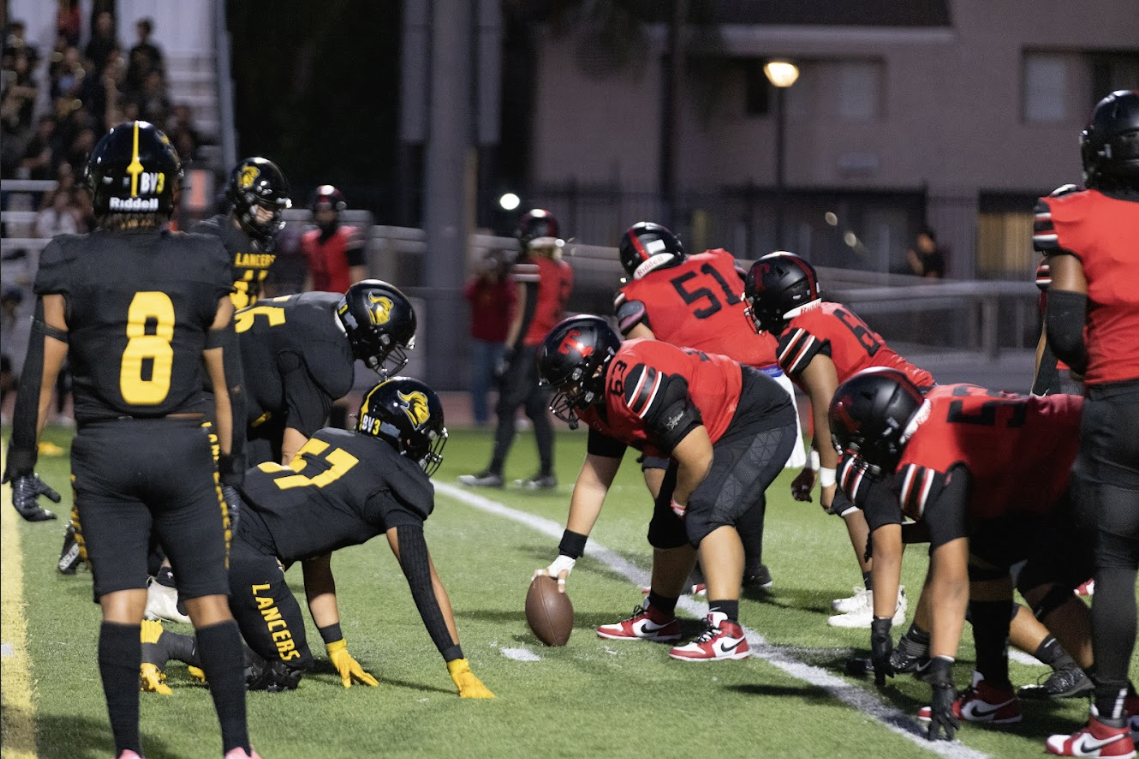 Lancer football players prepare to defend the Troy Warriors at the 15-yard line in the second quarter of the Battle of the Nations match on Friday, Aug. 23.