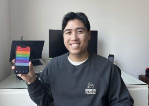 Class of 2015 alumnus Adrien Truong holds his phone displaying his Gradekit app at his home on Sunday, Nov. 3. Truong has been working on the app since 2014.