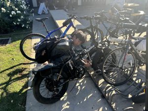 Freshman Florenzo Tenazas unlocks his e-bike after fifth period on Thursday, Nov. 7, between the 20s and 40s wings. Since the beginning of the 2024-2025 school year, more electric forms of transportation can be seen at the two bike racks on campus.