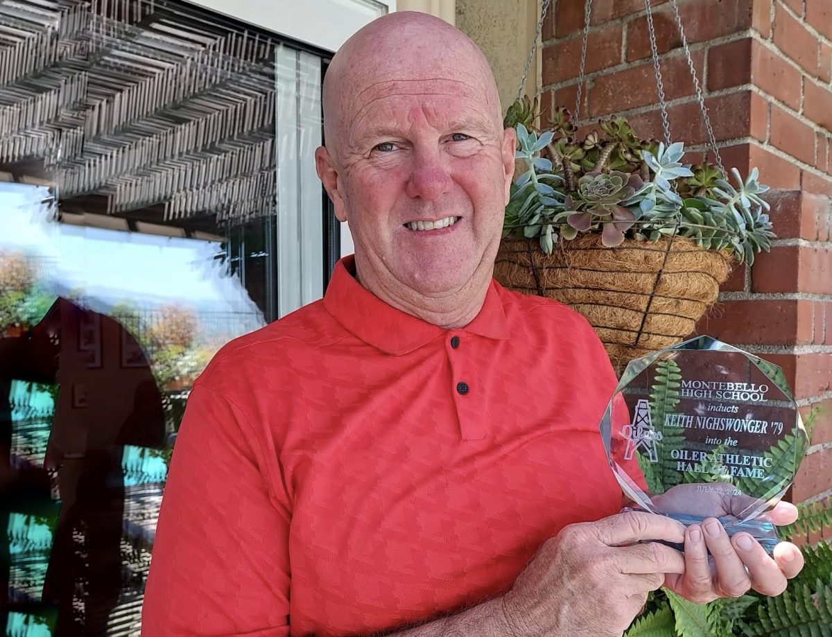 Keith Nighswonger holds the crystal award commemorating his induction into the Montebello High School Hall of Fame.
