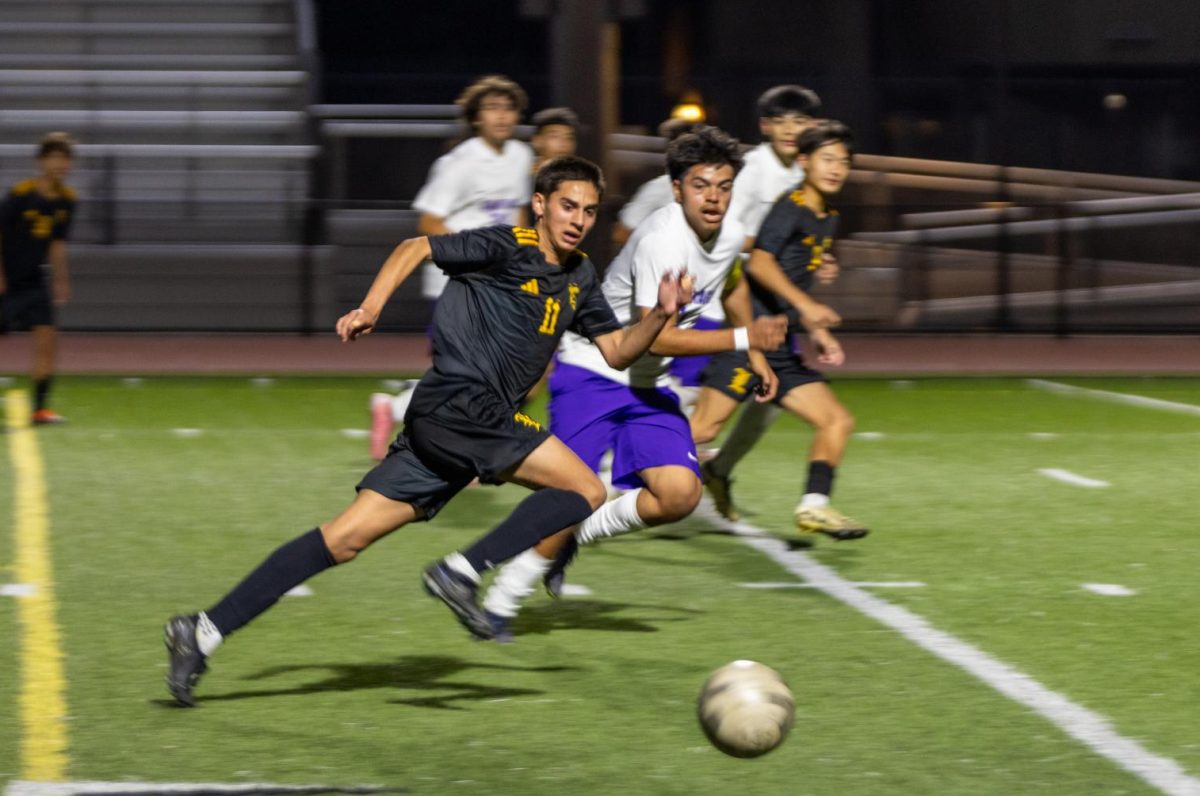 Senior Zachary Cardona sprints to the ball, passing Santiago High School defenders, to look for a shot at a goal at Buena Park High School stadium on Thursday, Nov. 21.