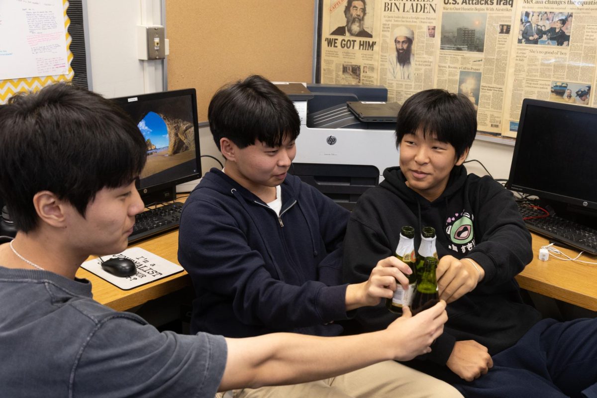 Accolade seniors Teo Jeong (left), Justin Pak and Nathan Lee celebrate the Pacemaker recognition with Martinelli’s sparkling cider during fourth period on Tuesday, Nov. 12, in Room 138.