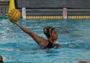 Sophomore Maddie Ramirez aims to score a goal near the goal during the first girls varsity water polo game of the 2024-2025 season on Wednesday, Nov. 20, after school at the pool.