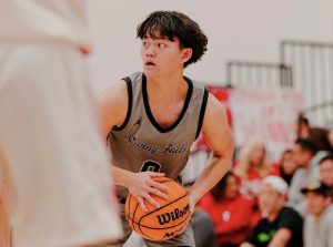 Shooting guard junior Jayden Bai holds the ball, preparing to pass to his teammate during an away game against Fullerton Union Tribes on Tuesday, Dec. 10.