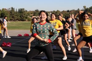 Senior, base Mackenzy Jung dances during cheer practice after school on Wednesday, Dec. 18, 2024, behind the gym in preparation for their first competition on Saturday, Jan. 11, 2025.