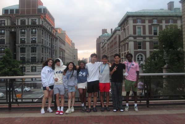 Junior Irene Park (third from the left) takes a picture with a digital camera with her friends on June 24 at the bridge in front of Columbia Law School.