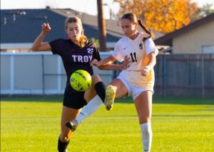 Forward junior Sophia Takaki attempts to steal the soccer ball from an opponent from Troy High School at an away game on Friday, Dec. 20, 2024, at 3 p.m. The Lady Lancers lost with a score of 3-4 during the preseason game.