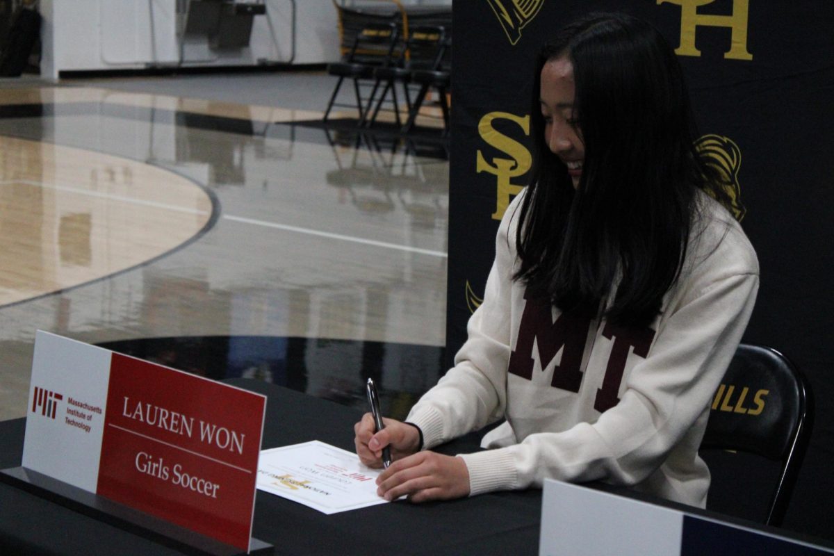 Girls soccer team captain senior Lauren Won signs a commitment letter to Massachusetts Institute of Technology during lunch on National Signing Day on Wednesday, Feb. 5, in the gym. 