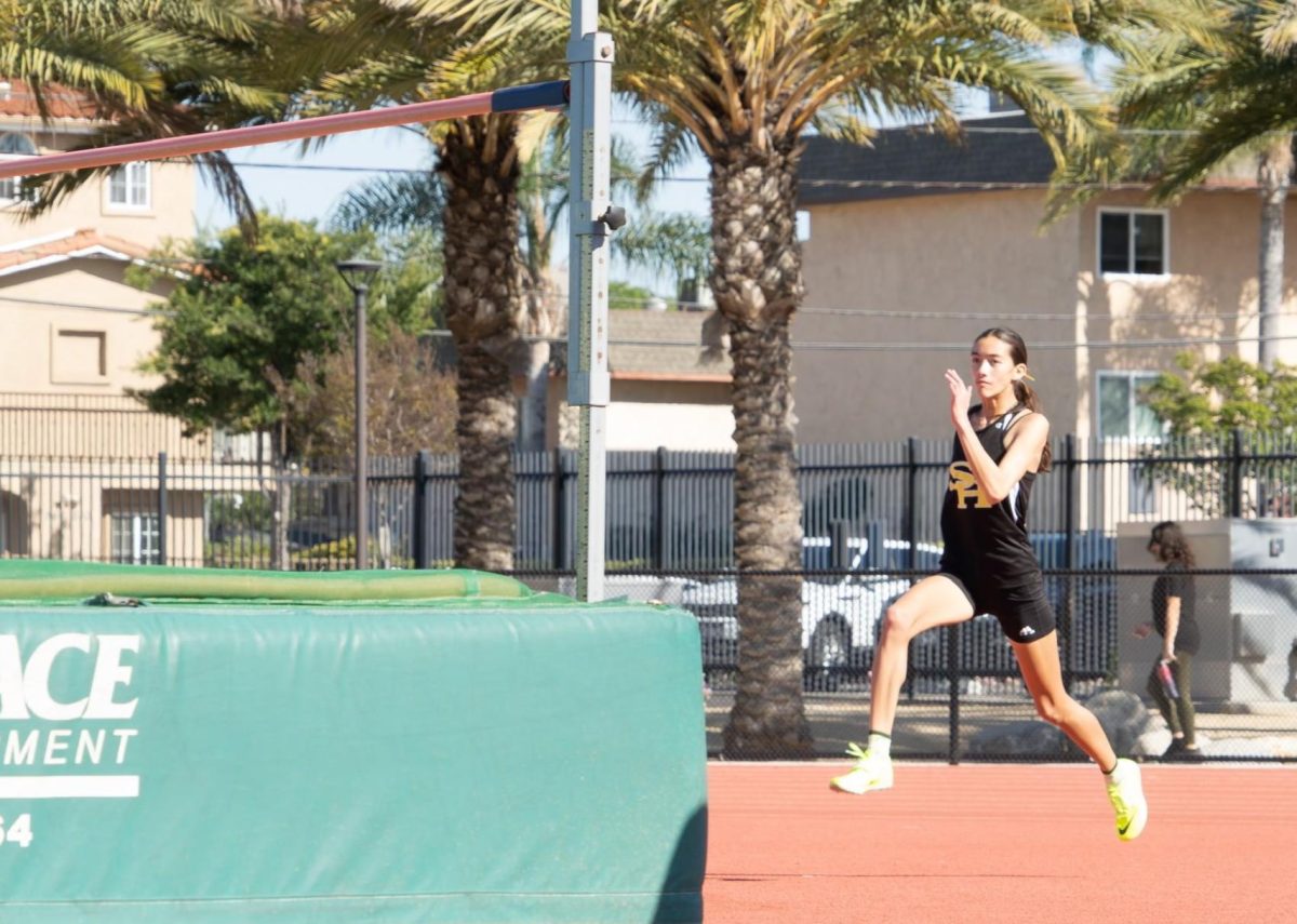 Sophomore Madelyn Sooter enters the takeoff zone for the high jump in an attempt to jump over the bar at the Freeway League quad meet No. 2 on Thursday, April 3.