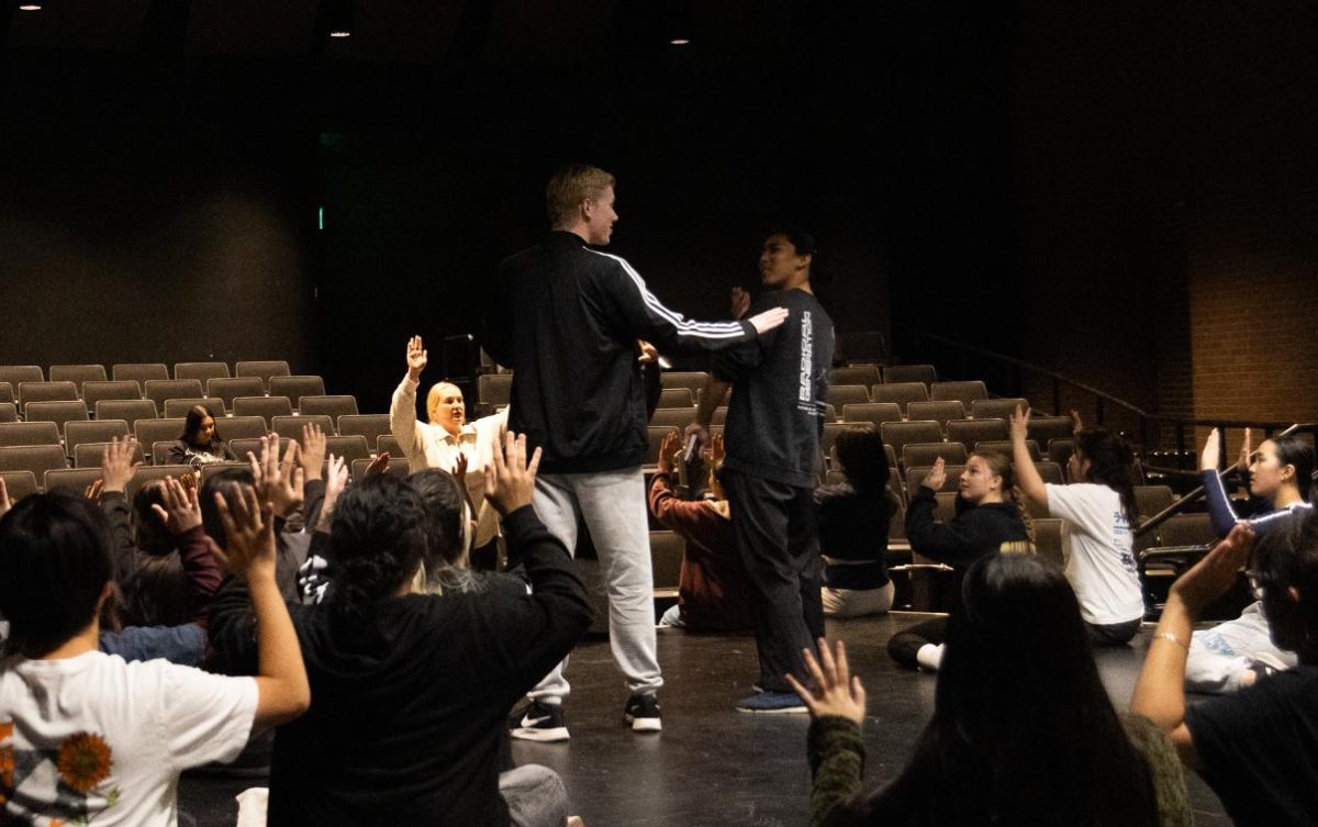 The cast of “Joseph and the Amazing Technicolor Dreamcoat” learns a dance from director Annie Pagano (center left) during rehearsal after school on Wednesday, Jan. 29, in the Performing Arts Center.