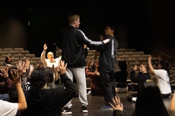 The cast of “Joseph and the Amazing Technicolor Dreamcoat” learns a dance from director Annie Pagano (center left) during rehearsal after school on Wednesday, Jan. 29, in the Performing Arts Center.