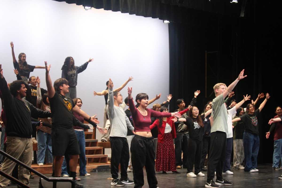 The students end with their arms wide open as the song “Go, Go, Go Joseph” comes to an end during their rehearsal for “Joseph and the Amazing Technicolor Dreamcoat,” on Wednesday, Feb. 19, in the Performing Arts Center.