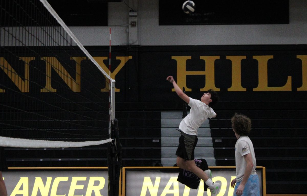 Opposite hitter senior Lucas Saab spikes the ball during the boys volleyball practice on Tuesday, Feb. 4, in the Sunny Hills gym.