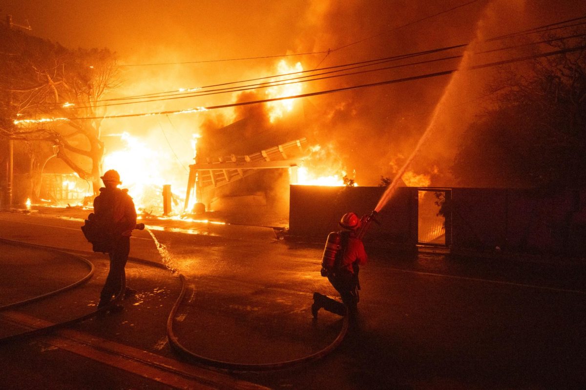 Firefighters combat the fires as winds continue to swell, facing the Palisades Fire along the iconic Malibu Pacific Coast highway on Tuesday, Jan. 7.