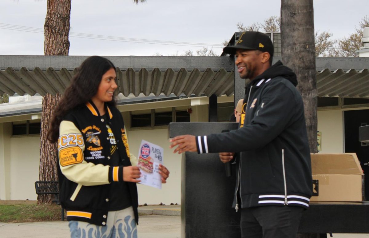 Soccer player senior Giselle Vargas (left) receives a Jersey Mike’s coupon for a free sandwich as a reward for being recognized as a Scholar Athlete of the Month during break on Tuesday, March 11, in the quad. Two others were recognized as an Athlete of the Month, while five others got a Scholar Athlete of the Month award for having the highest GPA in their sports program.