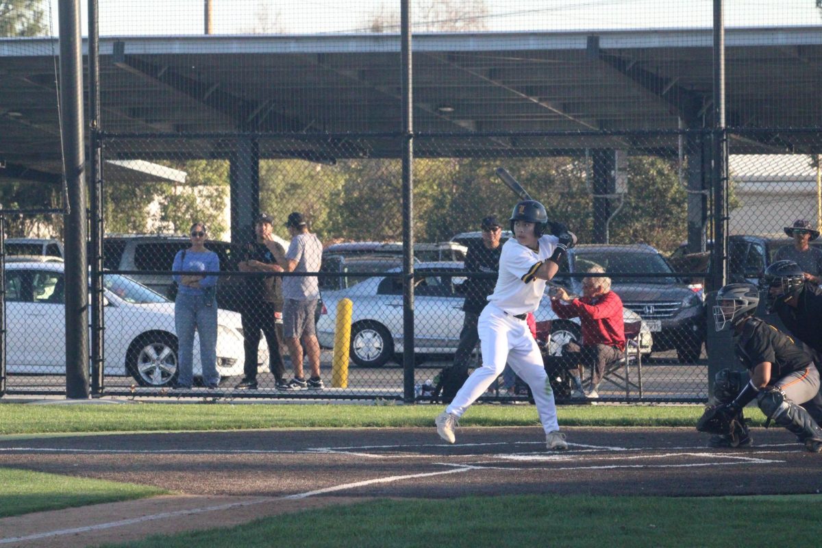 Pitcher senior Andre Katayama prepares to swing his bat during a home boys baseball game against Woodbridge High School at the baseball field on Tuesday, Feb. 25, after school. The opposing team won with a score of 6-1 against the Lancers.