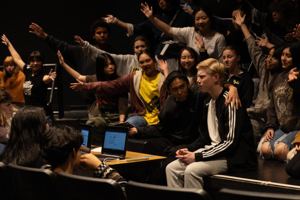 Senior Caleb Van Hook (right) rehearses by a panel for the musical "Joseph and the Amazing Technicolor Dreamcoat" on Wednesday, Jan. 29, in the Performing Arts Center.