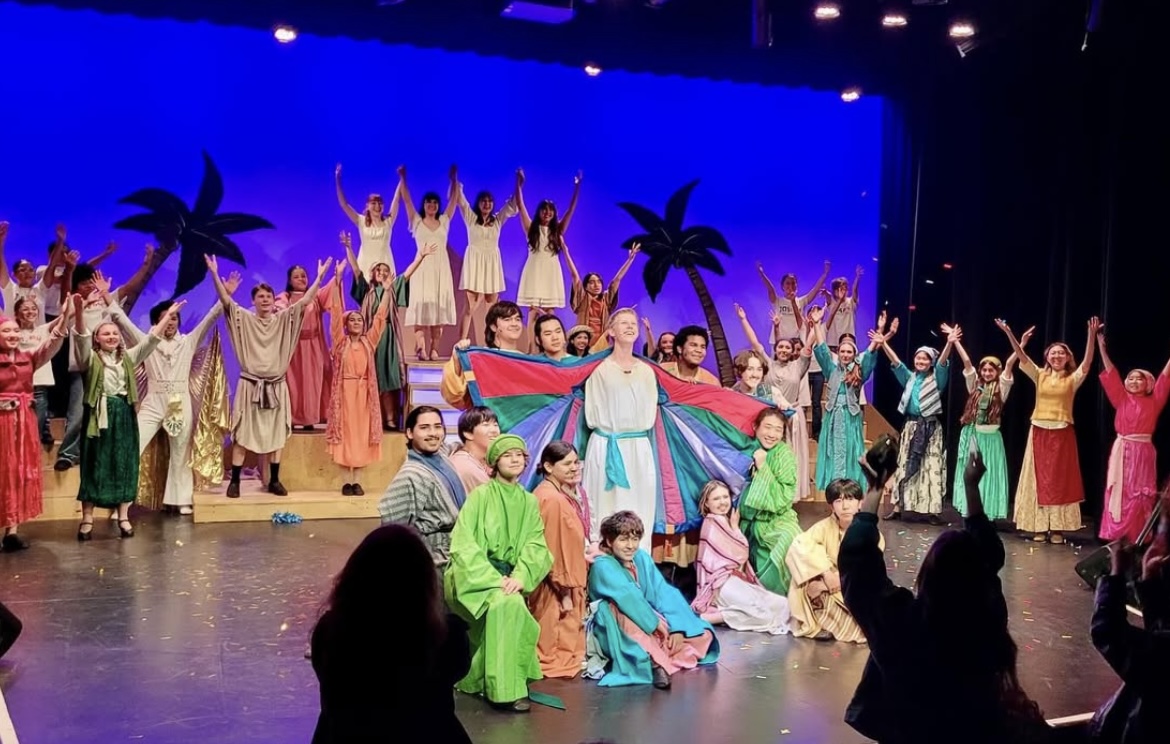 Joseph, played by senior Caleb Van Hook (center), displays his technicolor dream coat with the help of his brothers in the opening night of the musical on March 6, 2025 in the PAC. (Image used with permission from Spirit of the MACY awards)