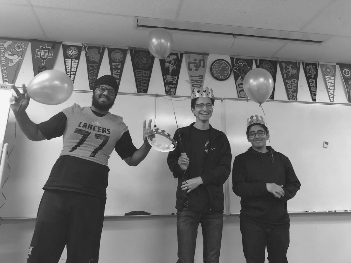 Then-seniors and Mr. Sunny Hills nominees Akashi Rai (left), Carlos Serrano and Jimmy Barajas stand up on Oct. 19, 2018 in their second period class with a balloon and paper crown as nominees for the Mr. Sunny Hills pageant show.