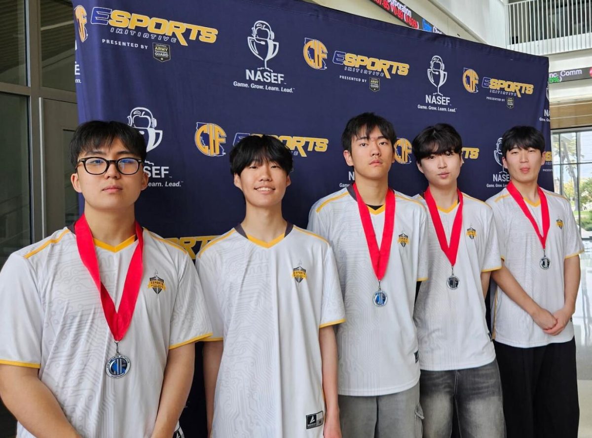 The League of Legends team stands in a line and shows off their second-place CIF medals on Saturday, April 26, at California State University, Dominguez Hills.