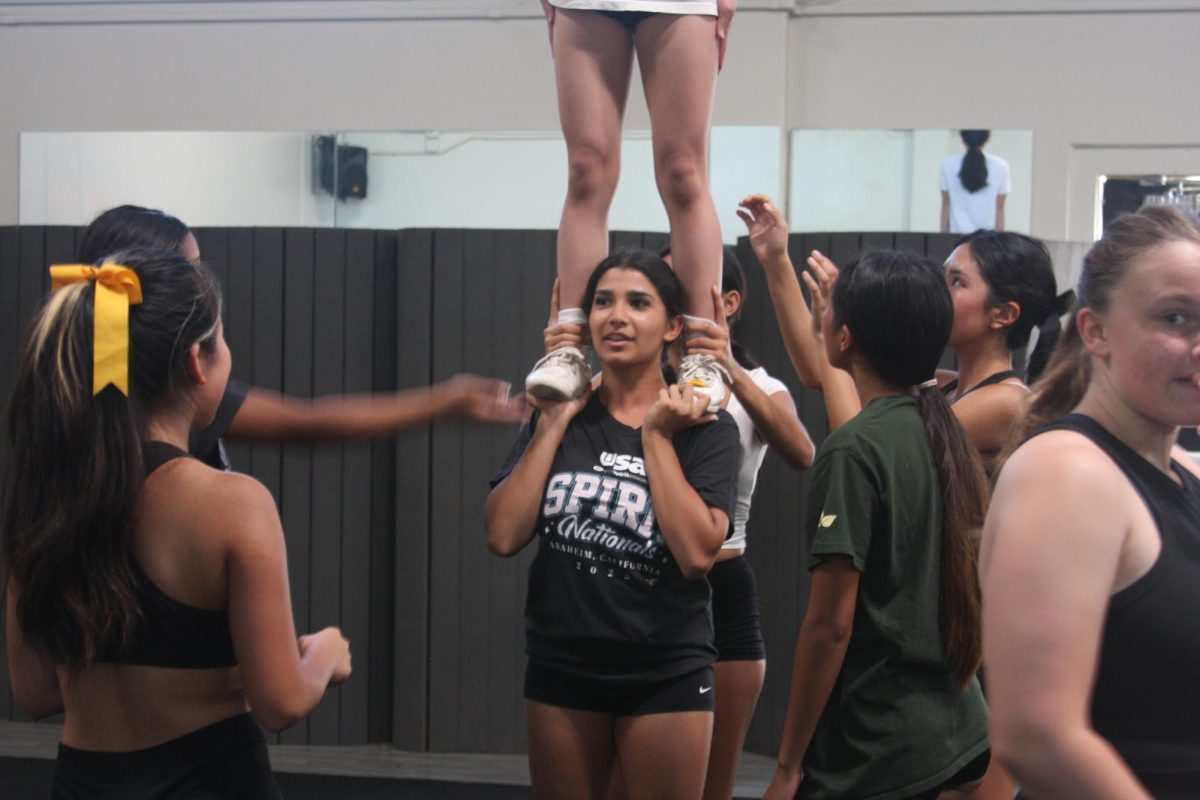 Base sophomore Sarina Desai practices lifting her teammate on her shoulders in the SH dance room on Wednesday, May 21.
