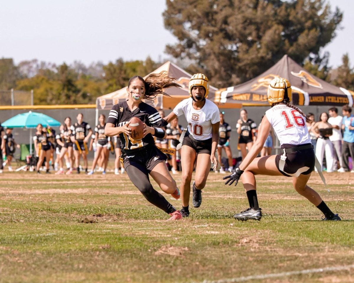 Quarterback sophomore Solaio Arredondo takes the run and scores the team a one point conversion in the first flag football game of the season on Monday, Aug. 11.