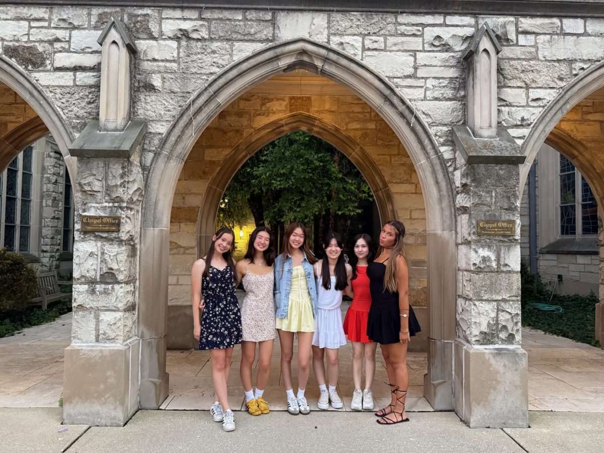 Senior Irene Park (third from the left) takes a picture with her friends in front of an archway near the Jones Hall dorms with her friends on July 24. 