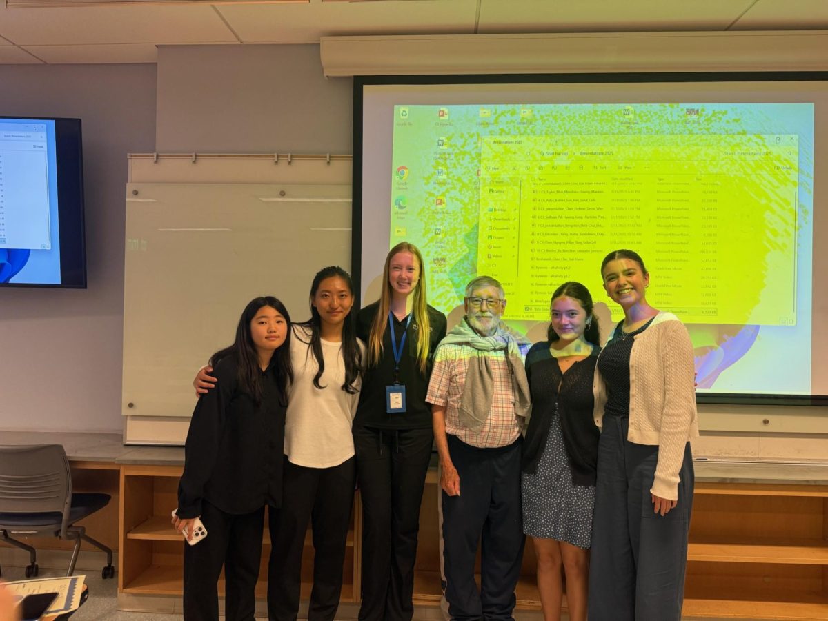 Junior Kyuwon Han (left) takes a picture with her cluster friends, professor and lab assistant on Aug. 1 at the Natural Sciences Building lecture room. 