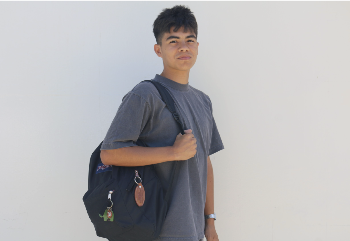 Junior Daniel Martinez holds onto his backpack in front of Room 138 on Thursday, Sept. 4. 