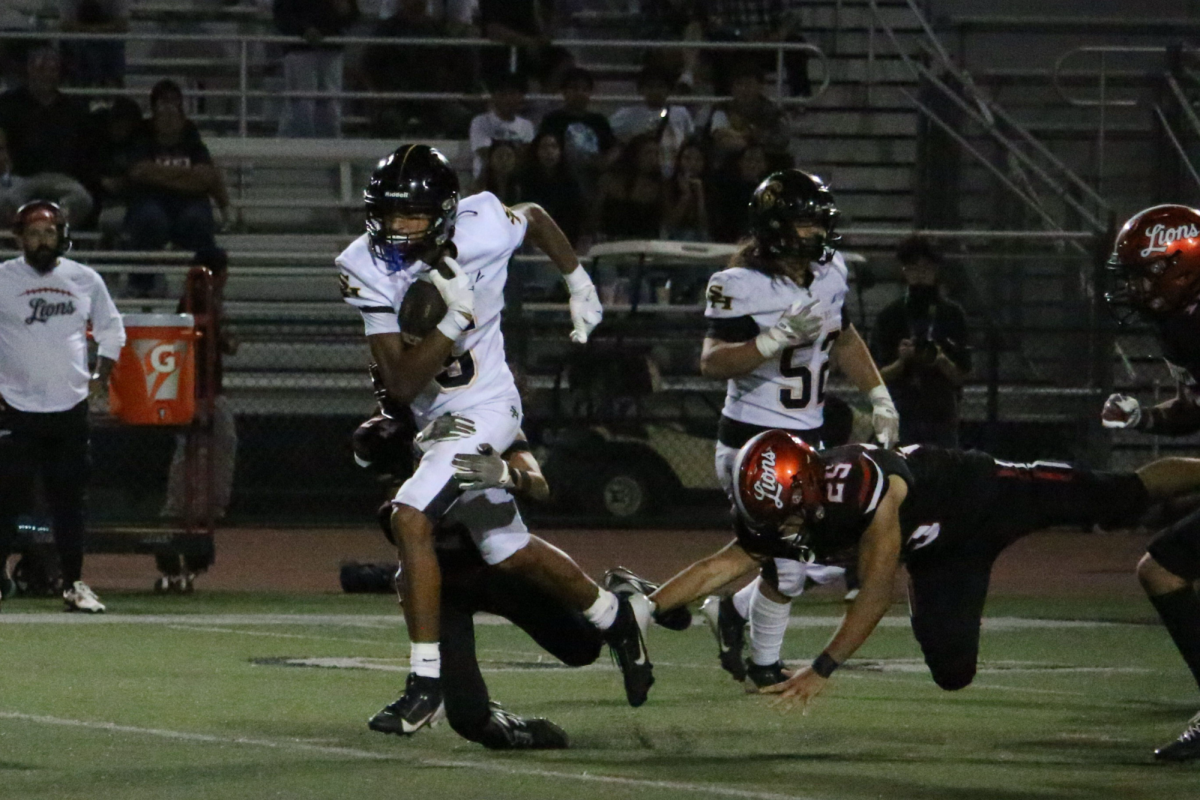 Wide receiver senior Kruz Sandle secures the win against Westminster High School on Friday, Aug. 22, ending the game with a catch for the offense.
