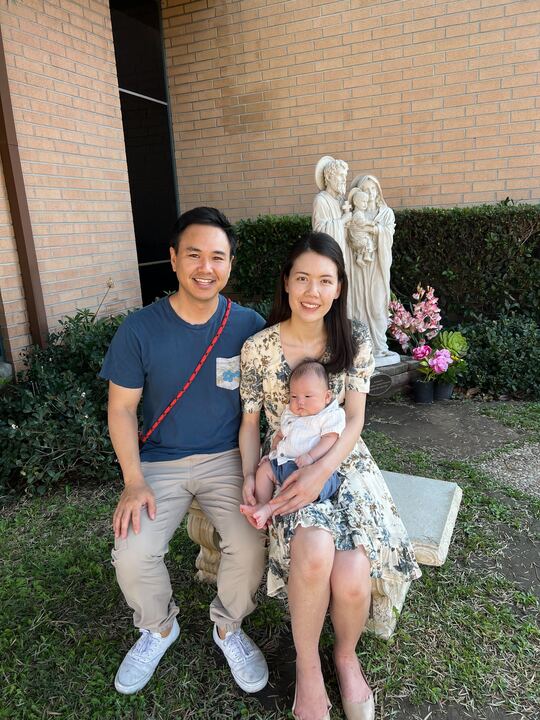 Algebra teacher Christina Nguyen holds her baby next to her husband, Kenny Nguyen. 

