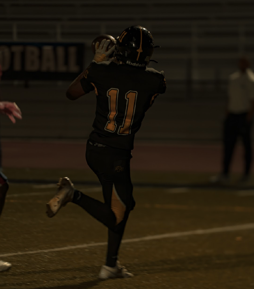 Senior wide receiver Pierrce Sandle catches the ball in the end zone, making his way to a touchdown on Friday, Oct. 10. The final score was 14-35.