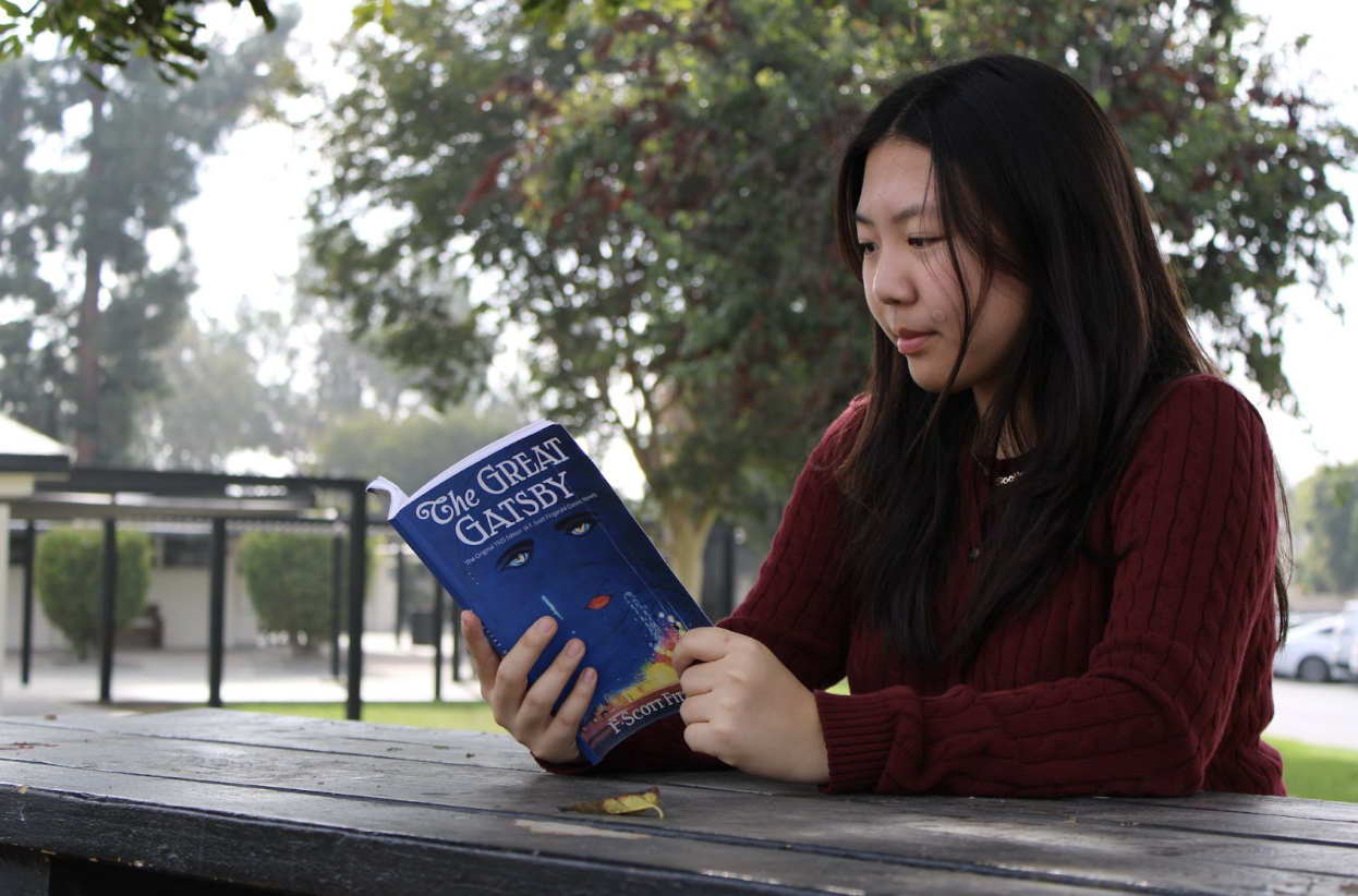 Senior Soojin Cho reads a physical copy of the novel The Great Gatsby, by F. Scott Fitzgerald, on Wednesday, Nov. 12. 