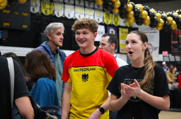German club president senior Thomas Oltman (left) and junior Eniko Barta (right) advertise for their foreign language classes during the Sunny Hills open house in the gym after school on Tuesday, Jan. 20.