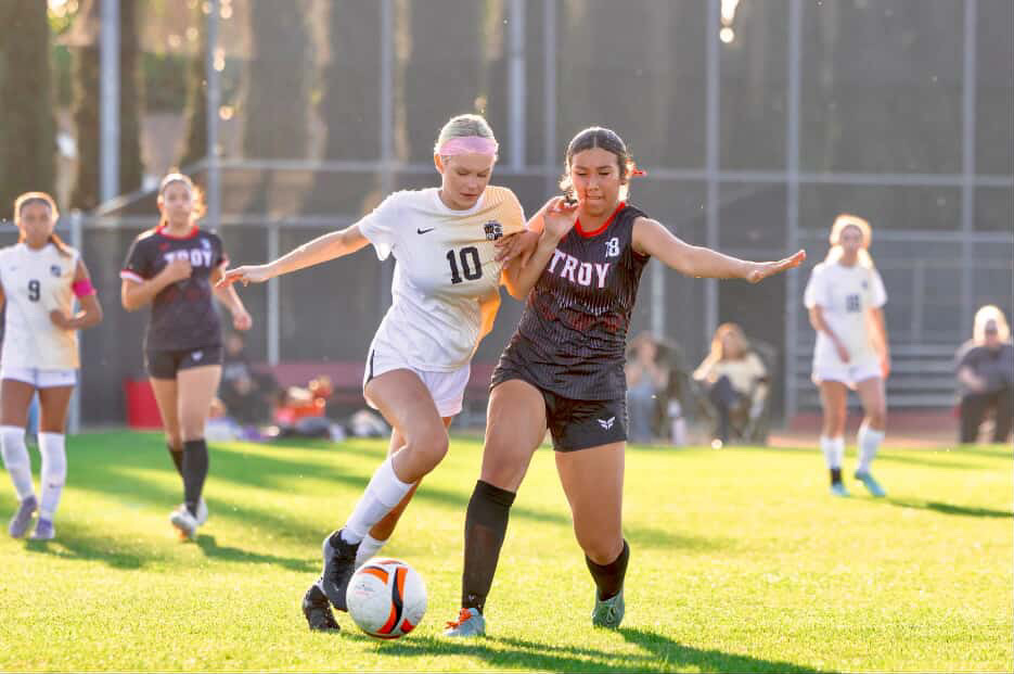 Center back sophomore Aspen Godbey steals the ball from Troy High School's forward player at an away game on Monday, Feb. 2.