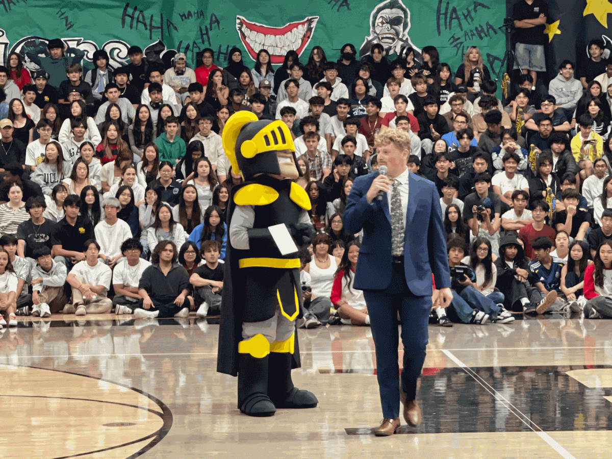Senior Aaron Green (right) introduces new mascot Winston the Lancer during the Homecoming assembly on Oct. 30, 2025.
