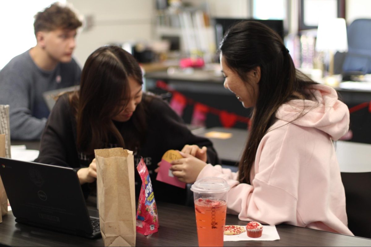 Seniors Katelyn Oho (right) and Kayleen Kim open Oho’s friendship envelope with kind notes during third period on Friday, Feb. 13, in Room 14. 